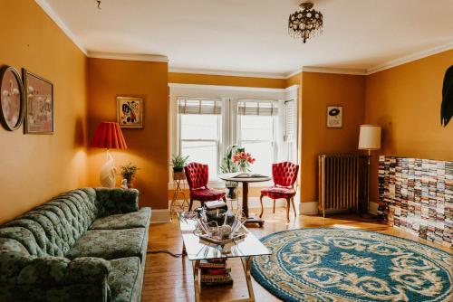 a living room with a couch and a fireplace at Retro Gem Box Victorian Steps from Irvine Park in Saint Paul