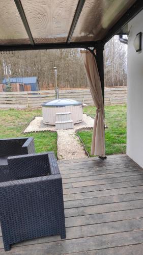 an outdoor patio with an umbrella and a fountain at Przystanek Przywidz in Trzepowo