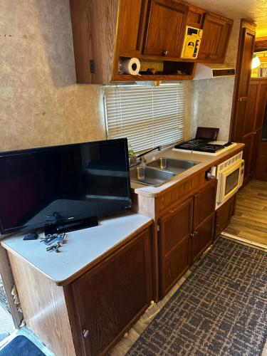a small kitchen with a sink and a stove at Black castle RV2 in Miami
