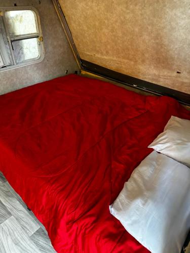 a red bed with white pillows in a room at Black castle RV2 in Miami
