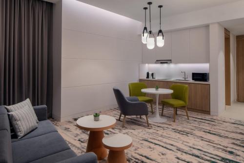 a living room with a couch and chairs and a table at Holiday Inn Dubai Business Bay by IHG in Dubai