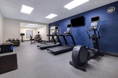 a gym with cardio equipment and a blue wall at Hampton Inn Natchitoches in Shamard Heights