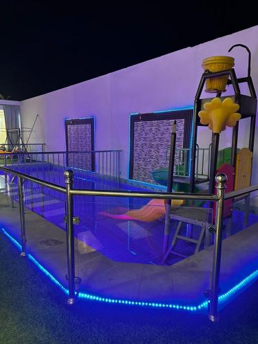 a childrens play area with a roller coaster at شاليهات بيوتي in Umm Salam