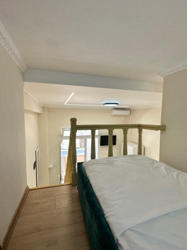 a bedroom with a bed in a room with a window at Troy ApartHotel Durres in Durrës