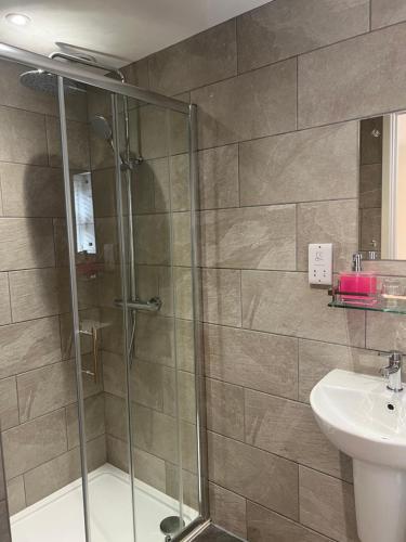 a bathroom with a shower and a sink at Priory Tearooms Burford with Rooms in Burford