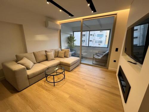 a living room with a couch and a table at BlueMotion - TwinBedroom Ν2 in Piraeus