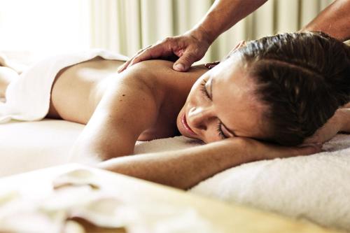 a woman laying on a bed getting a massage at ...mein Graml in Bad Füssing