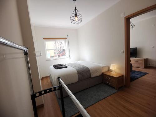 a small bedroom with a bed and a mirror at new sunny house! your home Lisbon apartment in Lisbon