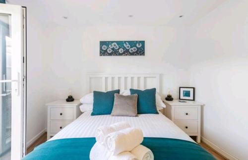 a bedroom with a bed with blue and white at The Cwtch in Brecon
