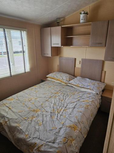 a bedroom with a large bed in a room at Palm Grove 110 in Chapel Saint Leonards