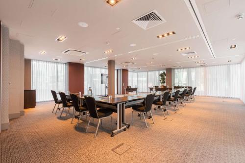 a conference room with a long table and chairs at DoubleTree by Hilton Hotel Newcastle International Airport in Newcastle upon Tyne