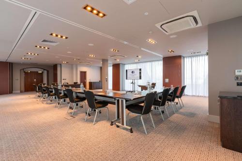 a conference room with a long table and chairs at DoubleTree by Hilton Hotel Newcastle International Airport in Newcastle upon Tyne