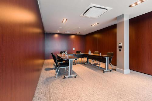 a conference room with a table and chairs at DoubleTree by Hilton Hotel Newcastle International Airport in Newcastle upon Tyne