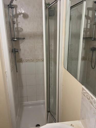 a bathroom with a shower with a glass door at 3 Bedroom Detached house in Wellingborough