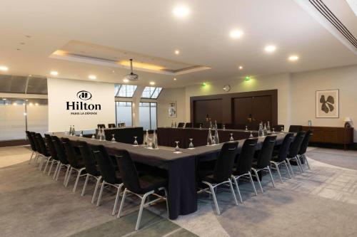 a conference room with a long table and chairs at Hilton Paris La Défense in Puteaux