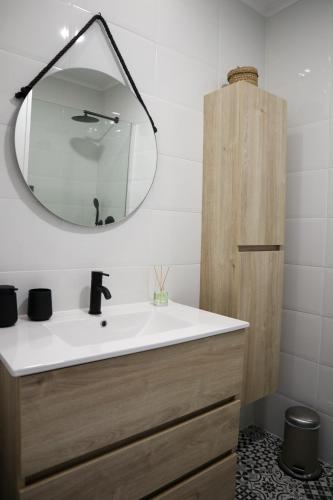 a bathroom with a sink and a mirror at Ana's Guesthouse in Sintra