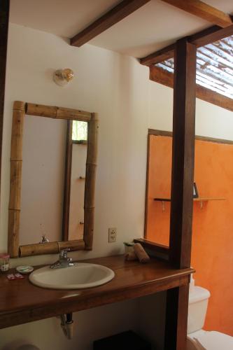 a bathroom with a sink and a mirror at Hotel Luz de Luna in Santa Teresa Beach