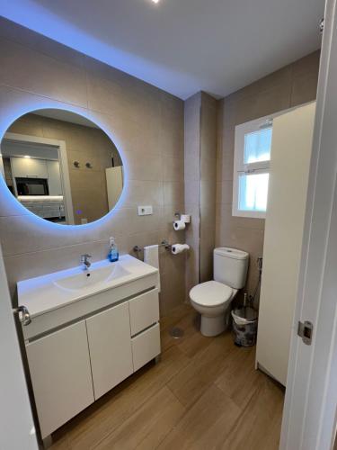 a bathroom with a sink and a toilet and a mirror at Hany apartment Ducado 7-C in Benidorm