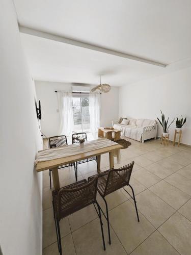 a living room with a table and chairs and a couch at Departamento en pleno centro de Corrientes in Corrientes
