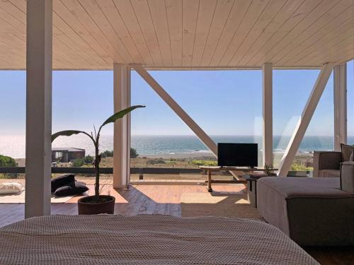 uma sala de estar com vista para o oceano em Espectacular Loft, a pasos del mar em Curanipe