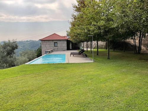 a swimming pool in a yard with a house at Casa da Prelada in Amarante