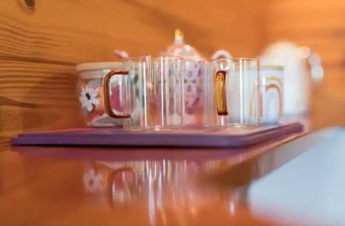 a group of cups sitting on top of a table at Krishna Farm Retreat in Coolabine