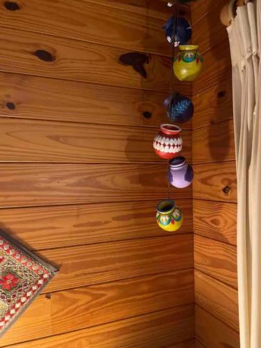 a room with a wooden wall with pots and pans at Krishna Farm Retreat in Coolabine