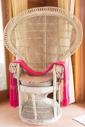 a wicker chair with a pink ribbon on it at Krishna Farm Retreat in Coolabine