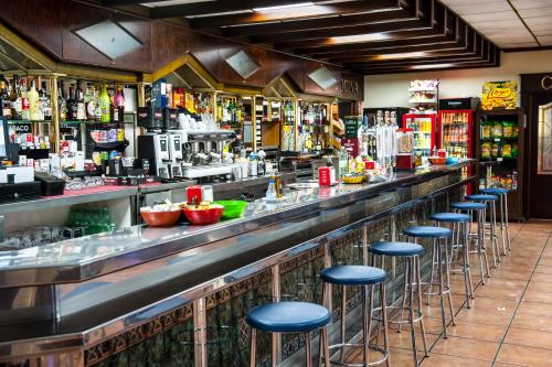 a bar with blue stools in a restaurant at HOSTAL LAS PALOMAS in Lucena