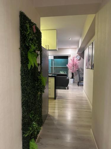 a hallway with a green plant on the wall at Apartment with 2 bedrooms next to Miraflores in Lima