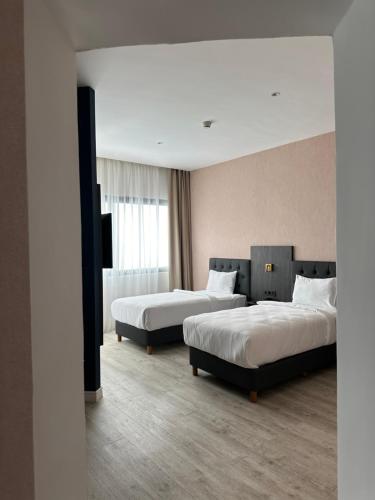 Un ou plusieurs lits dans un hébergement de l'établissement BOUMERDES PLAZA Hôtel & Spa