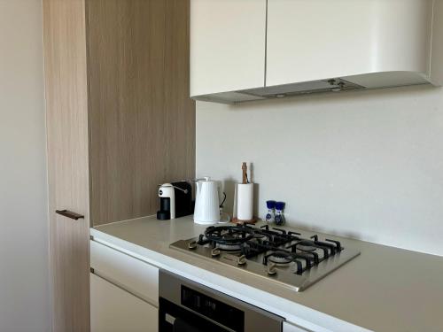 a kitchen with a stove top in a kitchen at Skygarden Luxury Condo in Glen Waverley