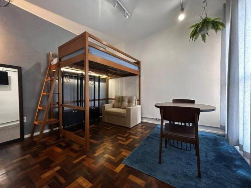 een kamer met een stapelbed, een tafel en een stoel bij Loft Master Coração Centro Histórico livre de enchentes in Porto Alegre