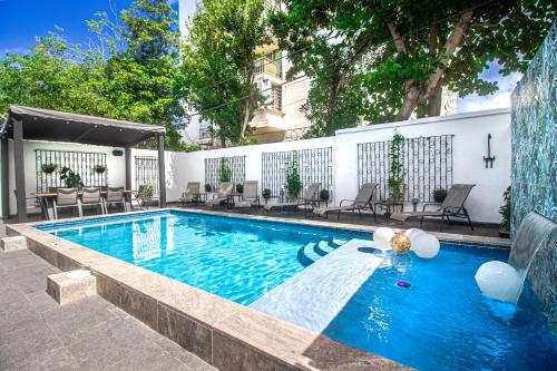 uma piscina com uma fonte em frente a um edifício em Villa Azure Ocean Park's Seaside Luxe Retreat em San Juan