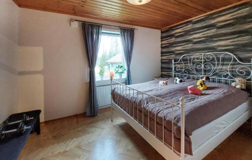 a bedroom with a bed with stuffed animals on it at Gorgeous Home In Gemla With Private Swimming Pool, Can Be Inside Or Outside in Gemla