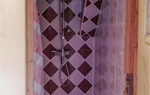 a bathroom with a shower with purple tiled walls at 2 Bedroom Awesome Apartment In Leba in Łeba