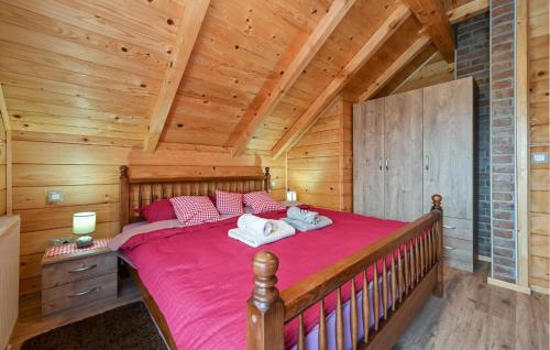 a bedroom with a large bed in a log cabin at Beautiful Home In Vinogradi Ludbreski With Heated Swimming Pool in Ludbreg