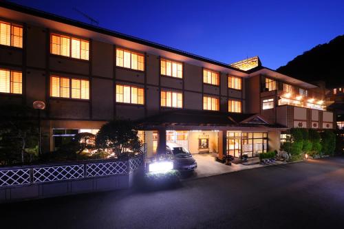 a building with a car parked in front of it at Suzukiya Ryokan in Shiroishi