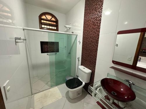 a bathroom with a glass shower and a toilet and a sink at Big House in Prado