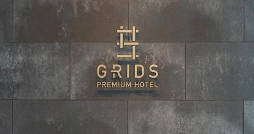 a sign on the side of a building at Grids Premium Hotel Kumamoto in Kumamoto