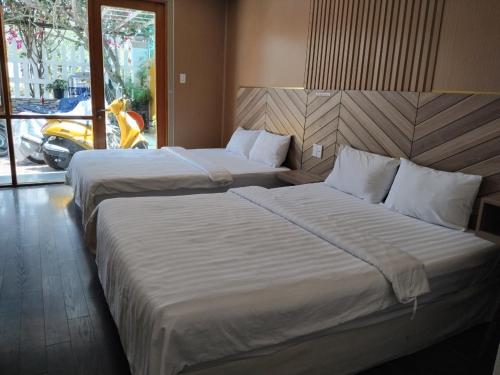 Кровать или кровати в номере Vindy House