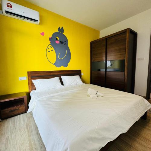 a bedroom with a bed with a chicken on the wall at Seaview 2B1R 6pax Condo Forest City 2E-2117 in Gelang Patah