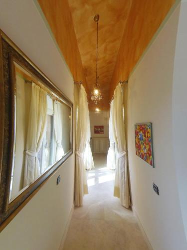 a hallway with white curtains and a wooden ceiling at Villa Stella Relax in Saturnia