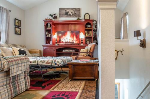 a living room with a fireplace and a couch at Sasquatch Lodge B sleeps 11 in Gatlinburg