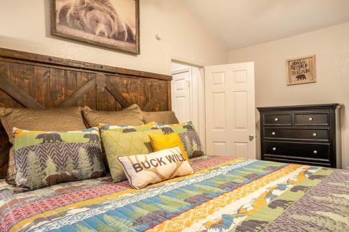 a bedroom with a bed with a wooden headboard at Sasquatch Lodge B sleeps 11 in Gatlinburg