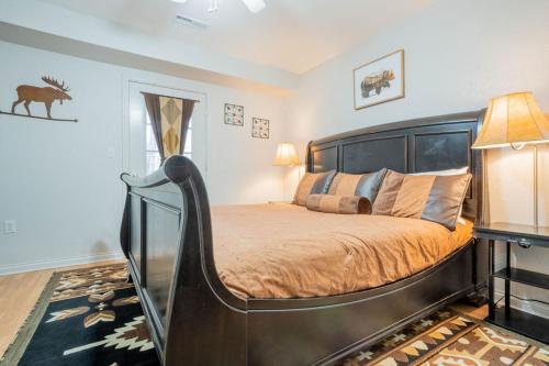 a bedroom with a large bed with a curved headboard at Sasquatch Lodge B sleeps 11 in Gatlinburg