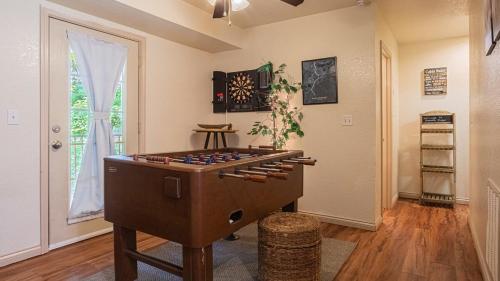 a room with a game table in the middle of a room at Cabin C in the Gatlinburg Art & Craft Community in Gatlinburg