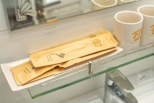 a shelf in a refrigerator with two cups of coffee at Hawal Boutique Villa Hoi An in Hoi An
