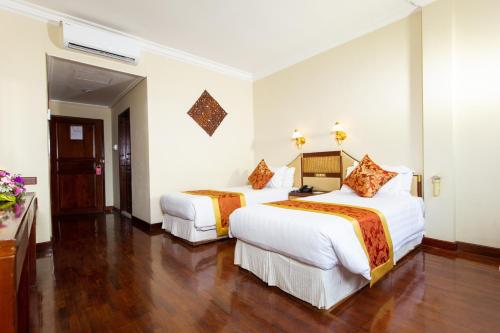 a hotel room with two beds in it at LAOTEL VIENTIANE in Vientiane