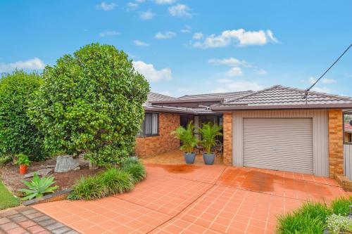 a brick house with a garage at 19 Pindari Parade Port Macquarie in Port Macquarie